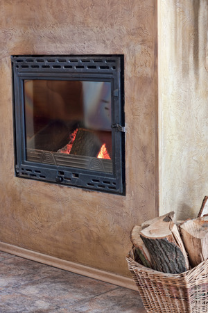 Burning fireplace in the house and chopped wood.Selective focusの写真素材