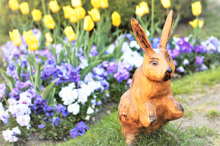 Art Easter bunny on spring green grass and flowersの写真素材