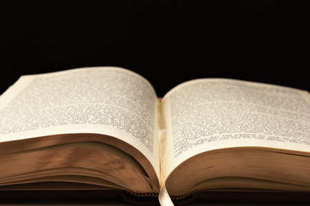 Old book. Isolated on dark background.の写真素材