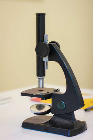 Optical microscope on white desk