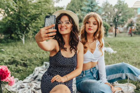 Two girls make selfie on a phone.の写真素材