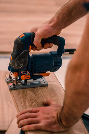 Man is cutting a board