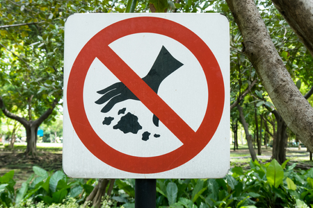Please Keep Area Clean the sign don't drop waste, no littering in the park in plants backgroundの写真素材