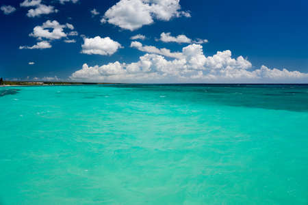 Tropical sea with turquoise water, blue sky and white clouds. Caribbean Sea, Dominican Republic.の写真素材