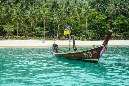 Tropical beach with turquoise water, white sand and boatの写真素材