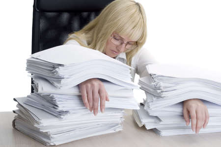 The woman the bookkeeper is filled up by a heap of workの写真素材