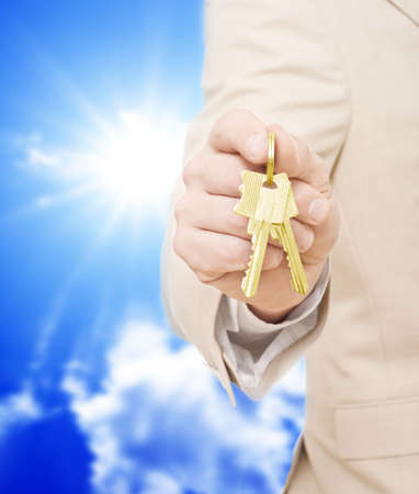Handing over the keys.Blue skies in the backgroundの写真素材