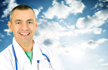 The smiling doctor against the skyの写真素材