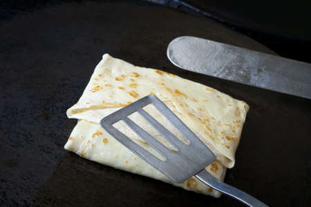 Making pancakes. Shovels overturn a pancakeの写真素材