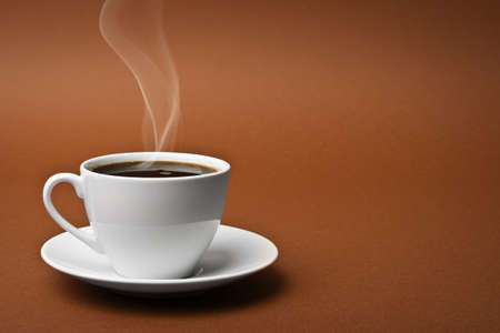 White cup on a saucer filled with coffeeの写真素材