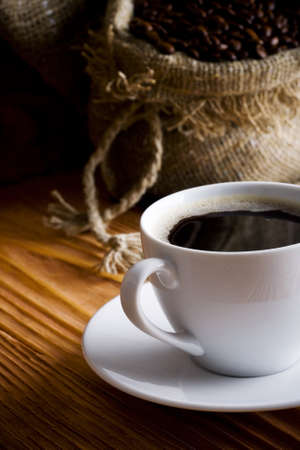 Cup of coffee. On a background a sack with coffee grainsの写真素材