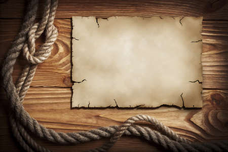 Ropes, old paper on a wooden backgroundの写真素材