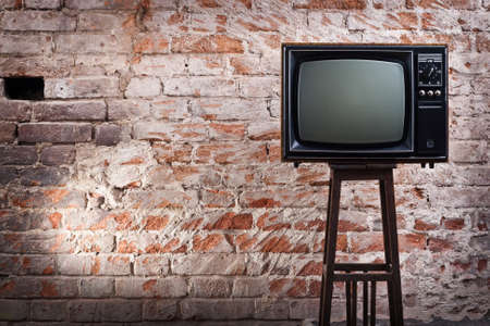The old TV set against an old brick wallの写真素材