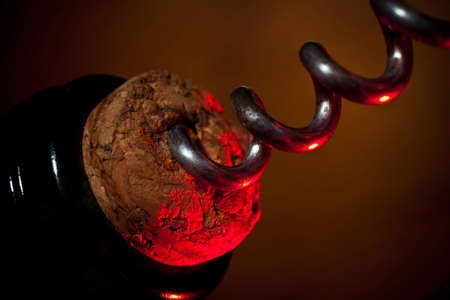 Opening of a bottle of wine by a corkscrew close upの写真素材