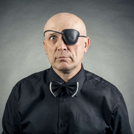 portrait of a man with a bandage on the eyeの写真素材