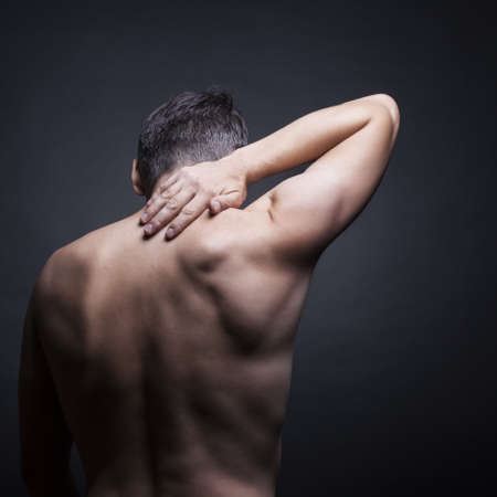 Pain neck. The back man.Black backgroundの写真素材