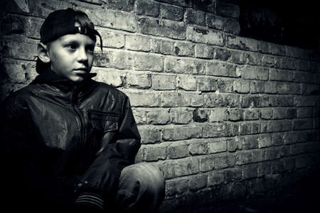 portrait of a teenager on a background of an old brick wall