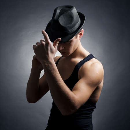 Dancer in hat. Black backgroundの写真素材