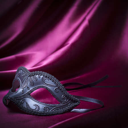 carnival mask on red fabricの写真素材