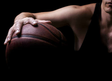 Basketball ball in a hand of the basketball playerの写真素材