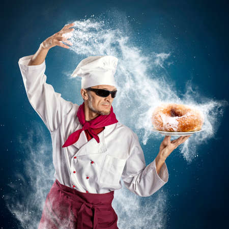 Chef sprinkle powdered sugar donutの写真素材