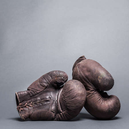 vintage boxing gloves on a gray backgroundの写真素材