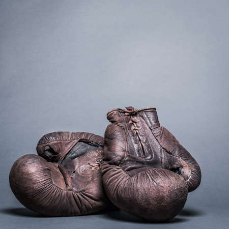 vintage boxing gloves on a gray backgroundの写真素材