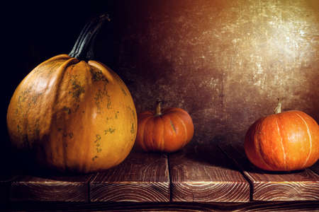 Pumpkins on old wooden backgroundの写真素材