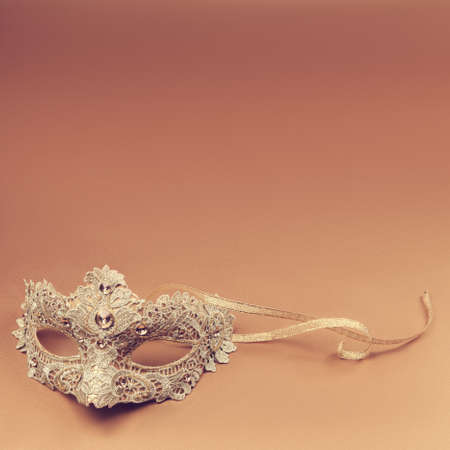 Carnival mask on an orange backgroundの写真素材