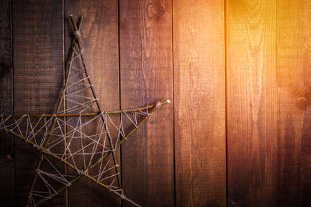 wooden star on a brown wooden backgroundの写真素材