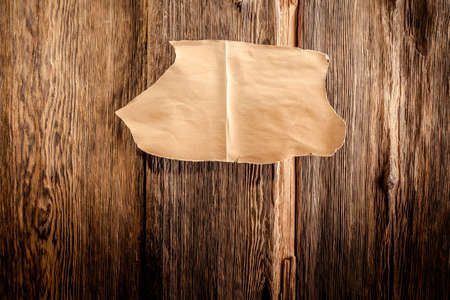 scrap of paper on an old wooden backgroundの写真素材