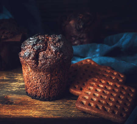 cupcake and cookies on a wooden background
