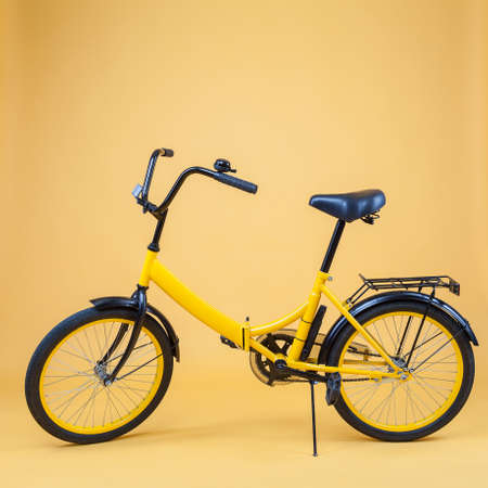 Children's bicycle on a yellow backgroundの写真素材