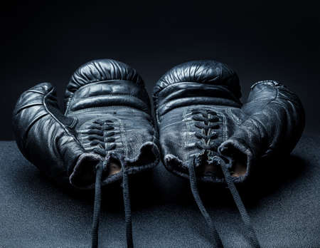 old boxing gloves on a dark background