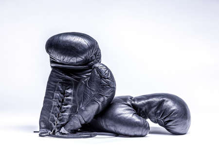 Old boxing gloves on a white backgroundの写真素材