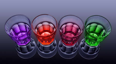 Colored faceted glasses on a dark backgroundの写真素材