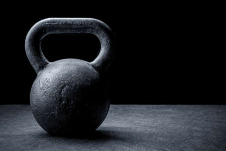 Black kettlebell on a black backgroundの写真素材