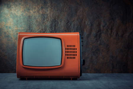 Old red tv against a dark background