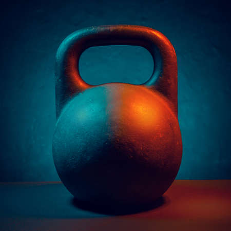 Kettlebell for training in the gym. Turquoise red lighting.の写真素材