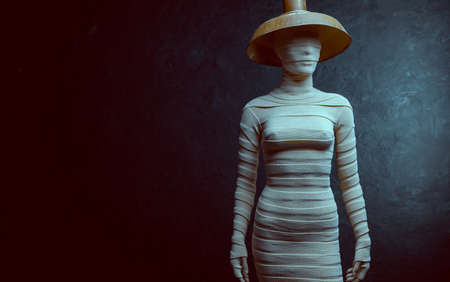 A female mannequin wrapped in an elastic bandage in the darkの写真素材