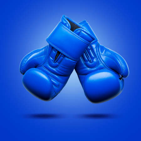 Blue boxing gloves on a blue background.