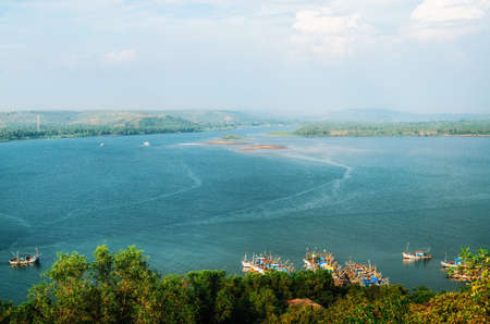 Chapora river with fish market and fishing boats. View of Chapora and Morjim coastline from Chapora Fort, North Goa, Indiaの写真素材