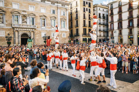 Barcelona, Spain - May 29, 2016: The Castellers de Barcelona of the Corpus Christi festival stand in front of the historical town hall with Giant puppets Gigantes and viewers.のeditorial素材