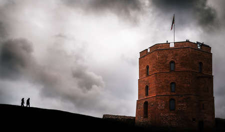 Two people silhouette go to the tower of Gediminas, Vilnius, Lithuaniaのeditorial素材