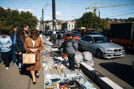 Tbilisi, Georgia - October 15, 2016: Traders and sellers of flea market on Dry bridge having a lot of vintage glasses, crystal, plates, handmade, souvenirs and retro staff for the customers.のeditorial素材