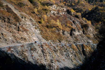 Car on the steep and shallow dangerous mountain road, Upper Zemo Svaneti, Georgiaの写真素材