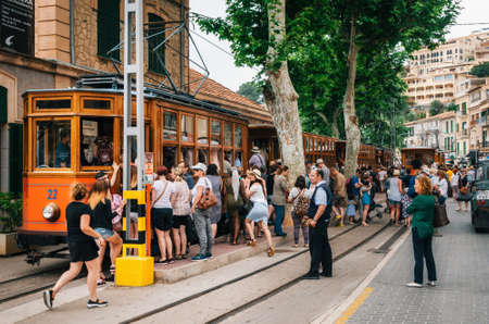 Port de Soller, Mallorca, Spain - May 26, 2016: A crowd of tourists get on the old vintage tram service going from Port de Soller resort to Soller. Landmark of Majorcaのeditorial素材