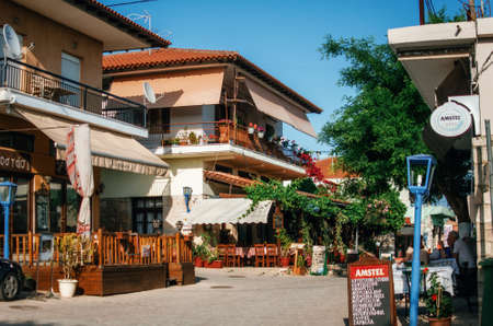 Afitos, Halkidiki, Greece - May 24, 2015: Typical buildings on the central square with cafes and restaurants in Greek resort of Afitos on Kasandra penisula, Halkidiki, Greeceのeditorial素材