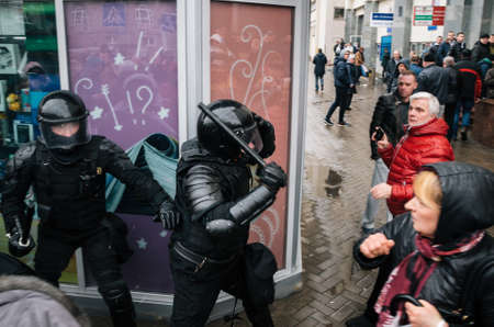 Minsk, Belarus - March 25, 2017 - Special police unit with shields against ordinary citizens and protesters. Belarusian people participate in the protest against the decree 3 Lukashenko and the current authorities.のeditorial素材