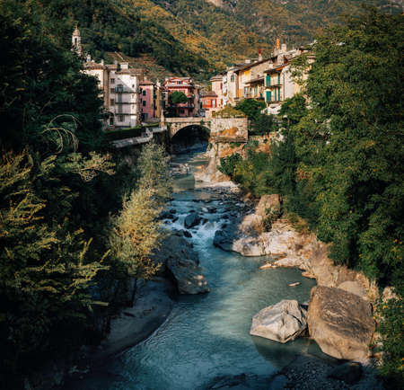 Scenic view on small river flowing through gorge between houses in cute town of Chiavenna, Italy.の写真素材
